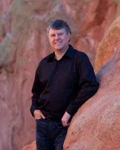 Dr. Pickle leaning on a large red rock