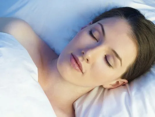 Woman laying on a white pillow